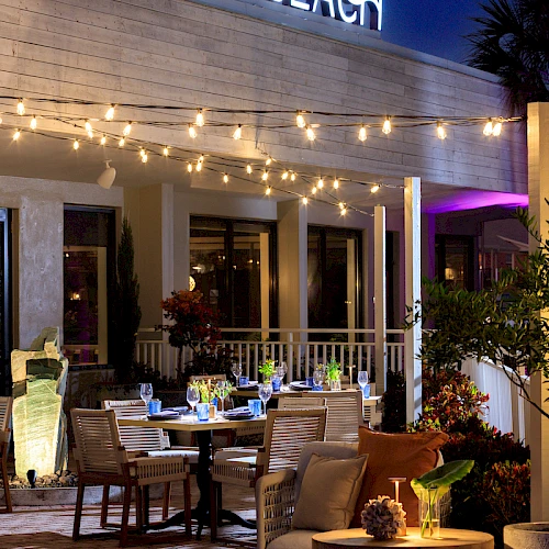 A stylish outdoor restaurant named Sky Beach with string lights, patio tables, and a warm evening vibe.